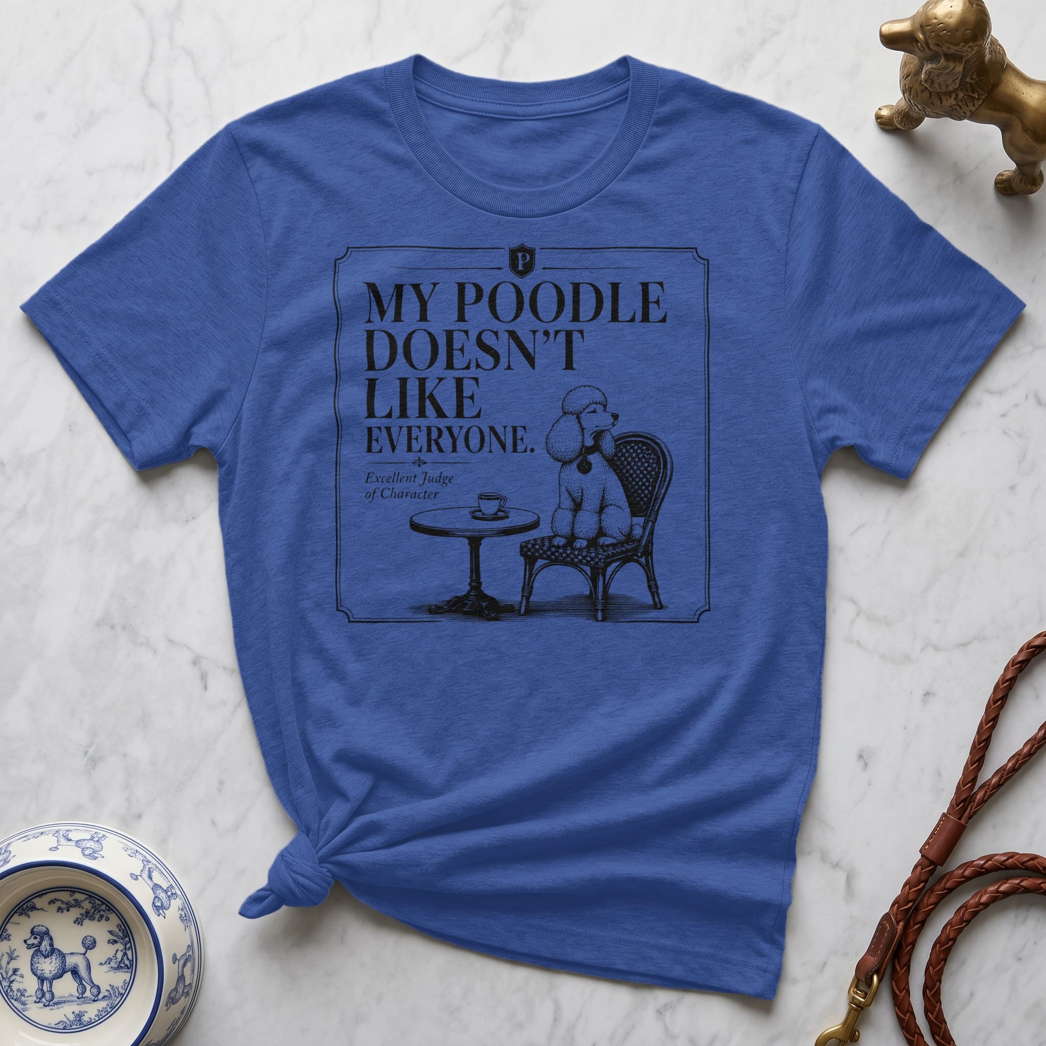 Blue t-shirt with "My poodle doesn't like everyone" text and poodle illustration.
