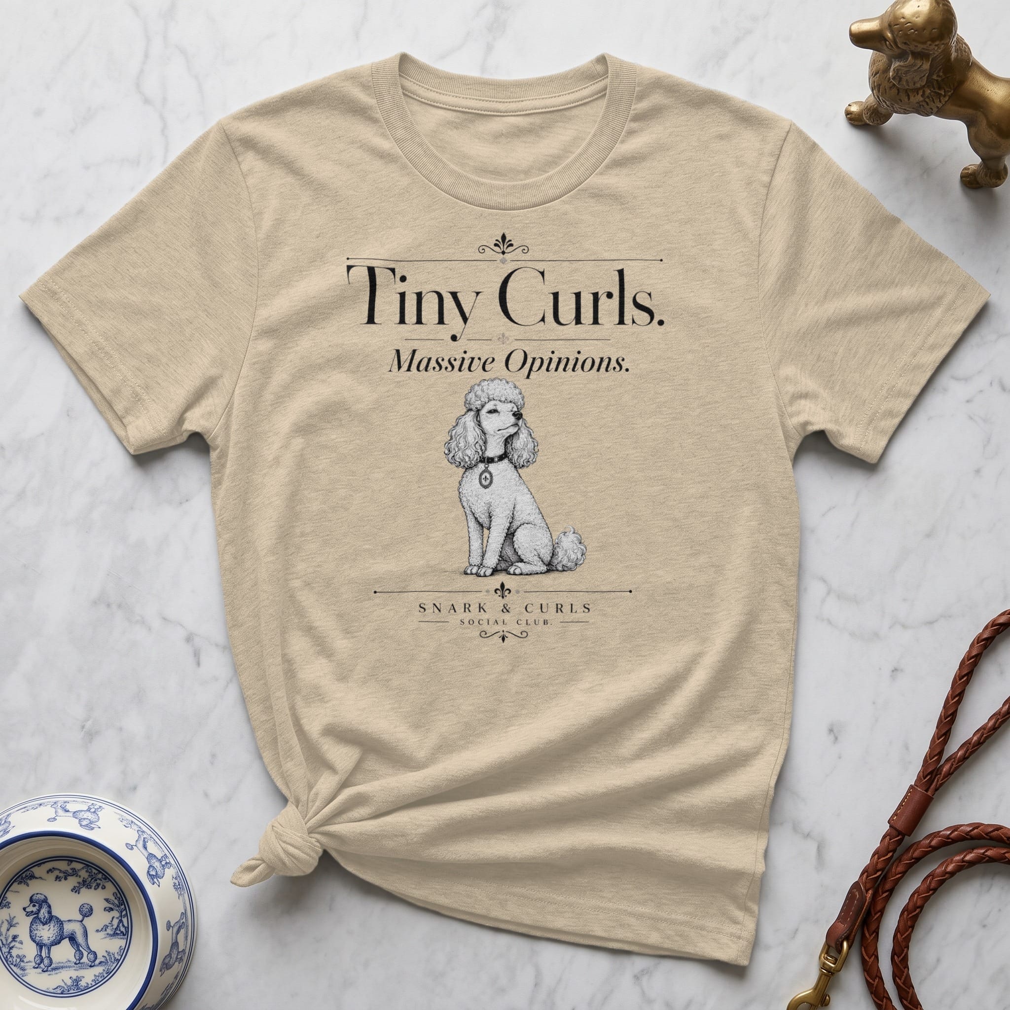 Cream t-shirt with "Tiny Curls. Massive Opinions." text and poodle illustration.