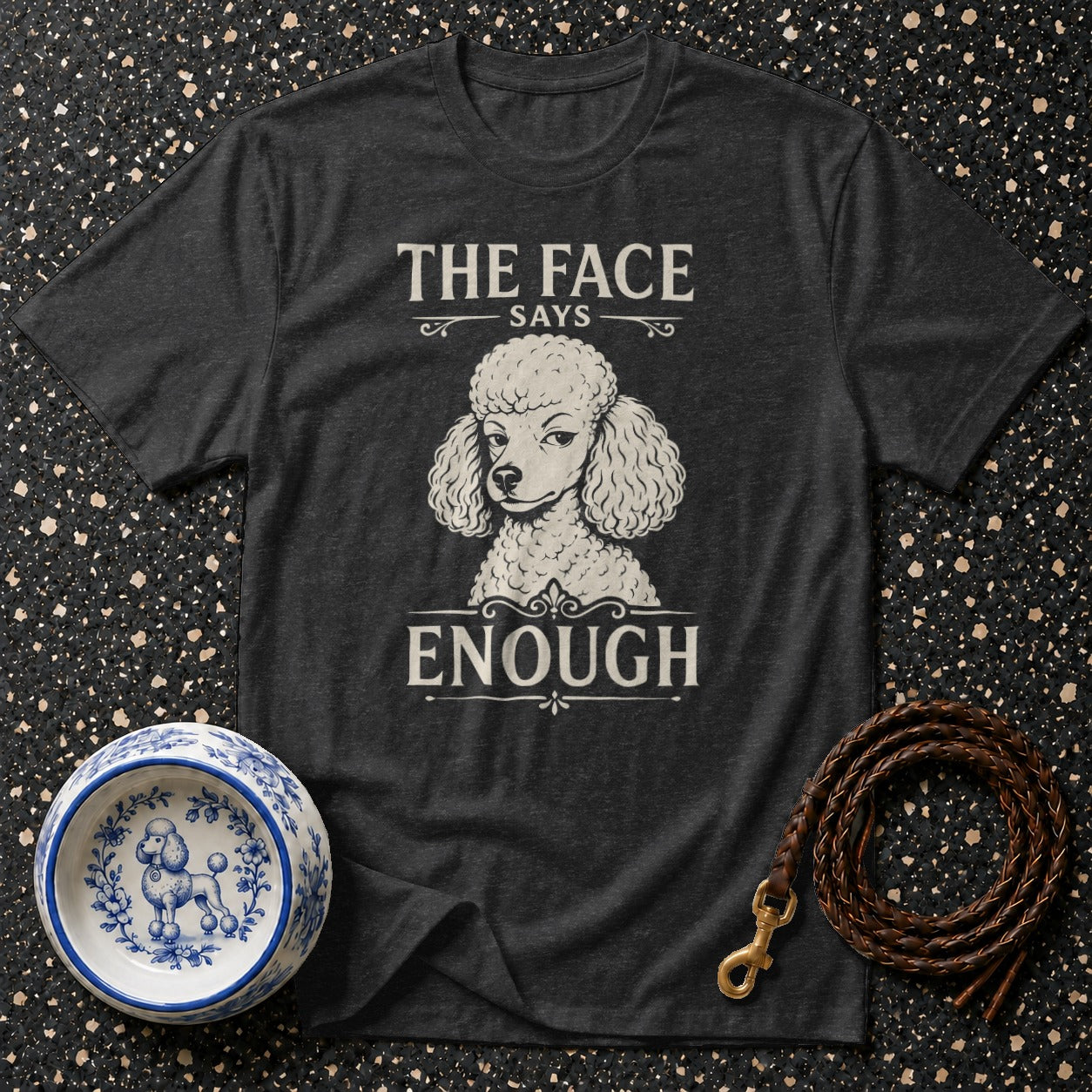 Dark t-shirt with poodle graphic and text "The face says enough".