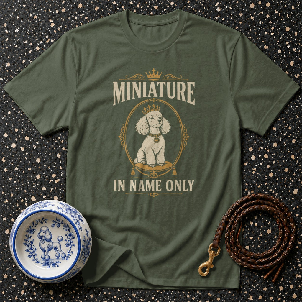 Green t-shirt with "Miniature in name only" text and crowned poodle graphic.