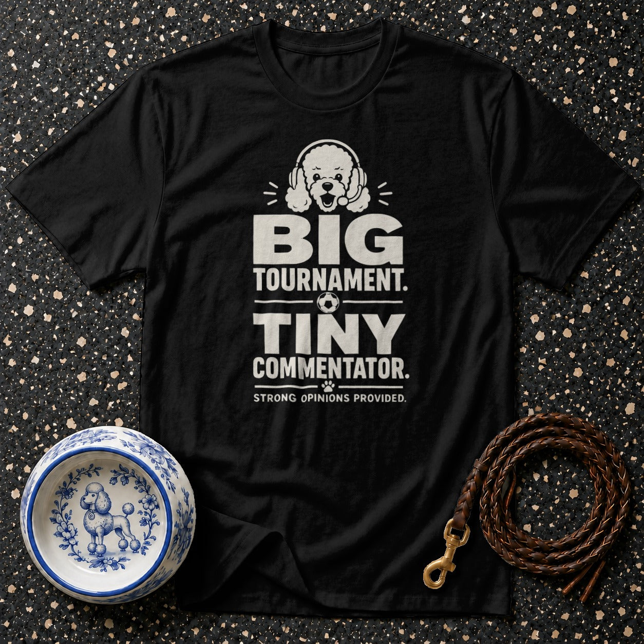 Black t-shirt with "BIG TOURNAMENT. TINY COMMENTATOR. STRONG OPINIONS PROVIDED." text and poodle graphic