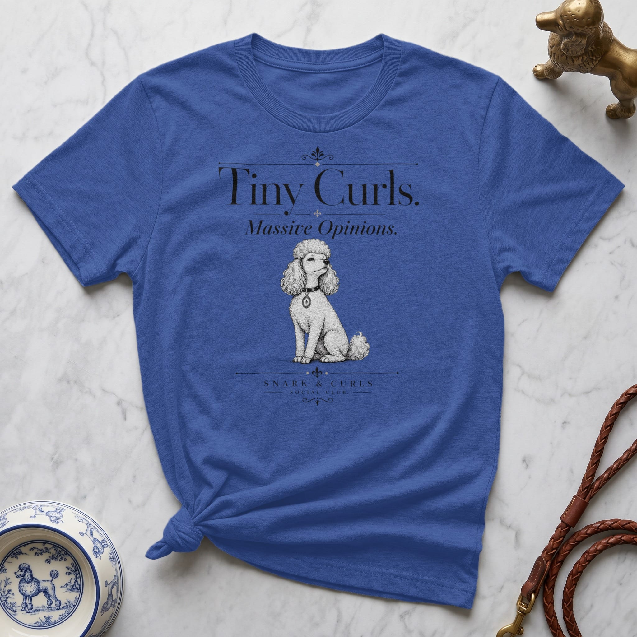 Blue t-shirt with a poodle illustration and text "Tiny Curls. Massive Opinions."