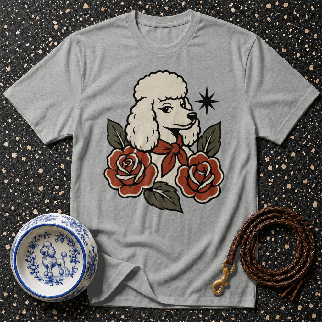 Grey t-shirt with poodle and rose graphic, blue and white dog bowl, leather leash.
