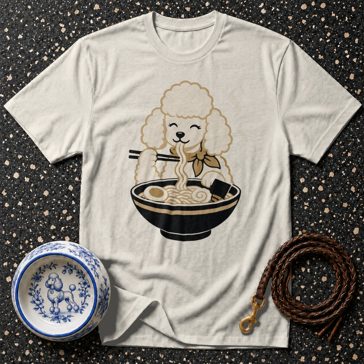 White t-shirt with a cartoon poodle eating ramen with chopsticks.