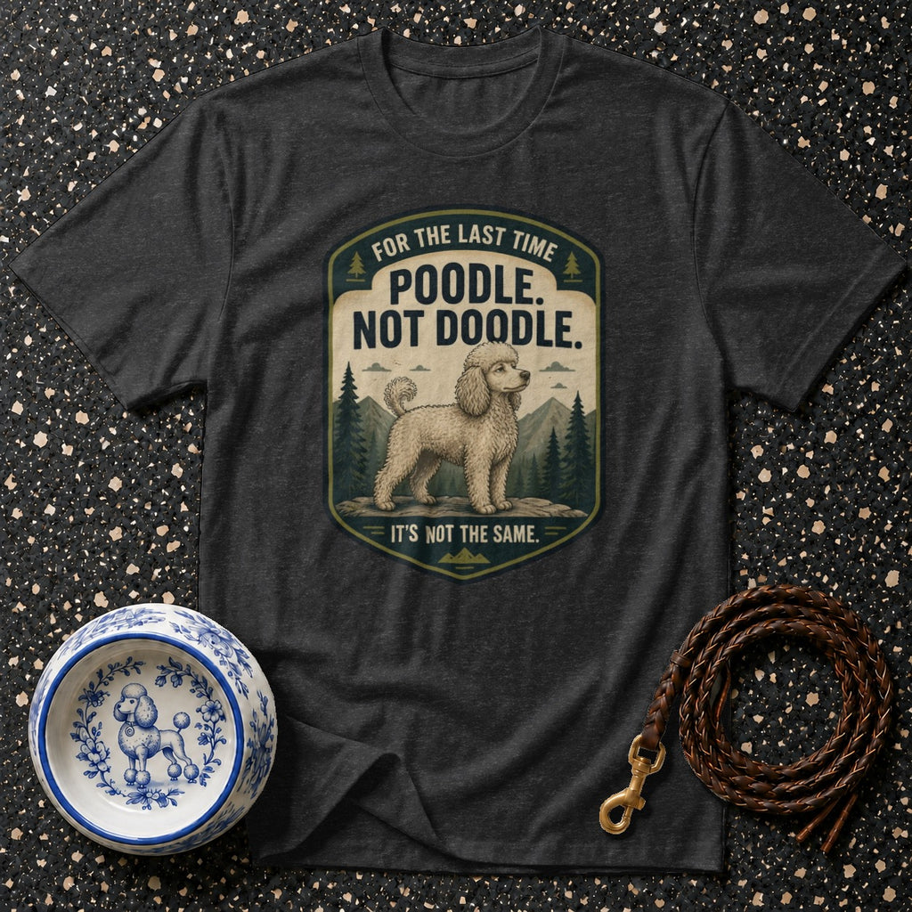 Dark grey t-shirt with a graphic of a poodle and text "POODLE. NOT DOODLE."