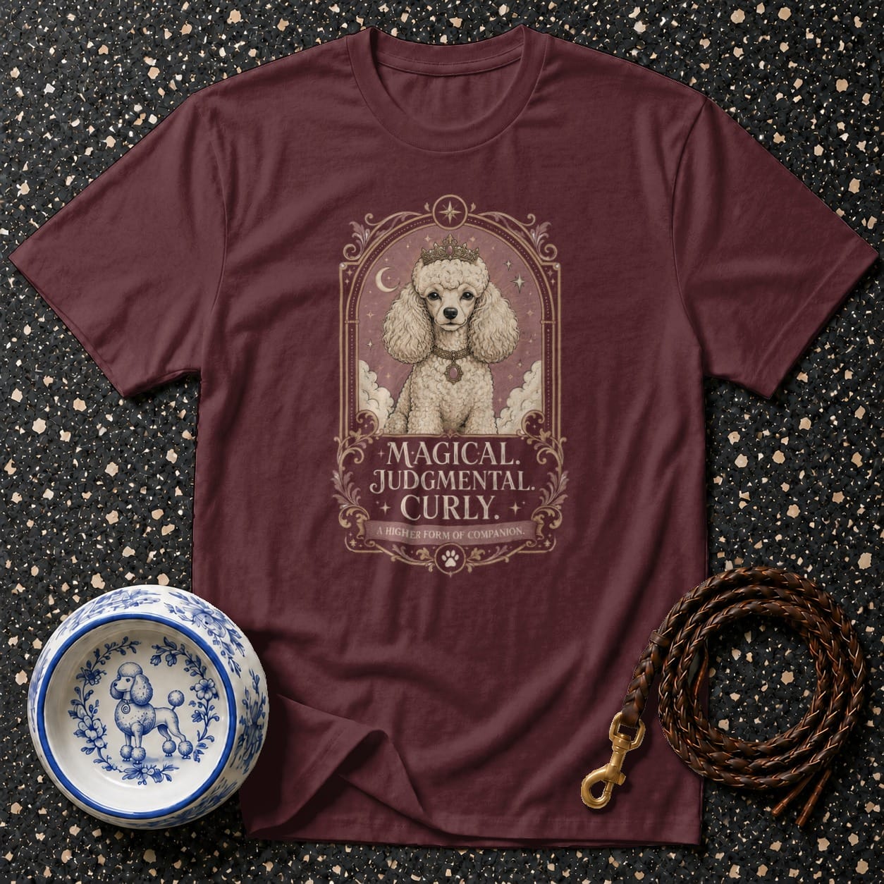 Burgundy t-shirt with a framed illustration of a judgmental poodle wearing a crown.