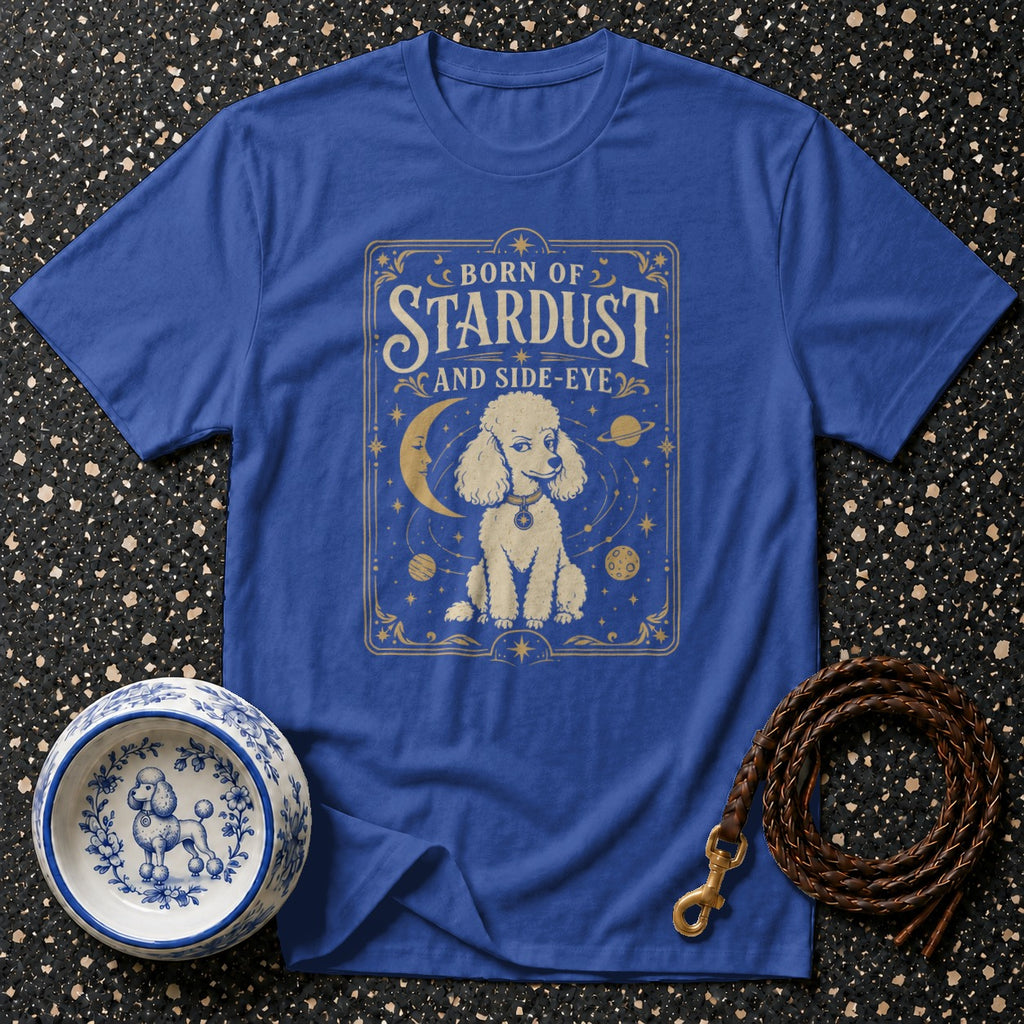 Blue t-shirt with poodle, moon, stars, planets, and text "BORN OF STARDUST AND SIDE-EYE".