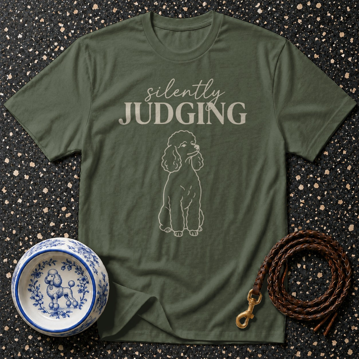 Olive green t-shirt with "silently JUDGING" text and poodle illustration.