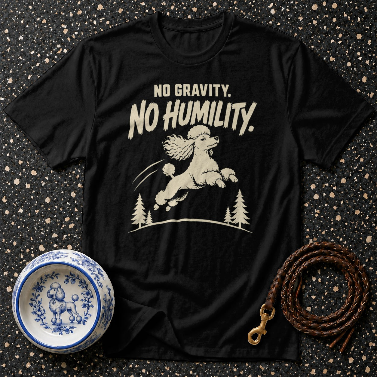 Black t-shirt with "NO GRAVITY. NO HUMILITY." text and a jumping poodle graphic.