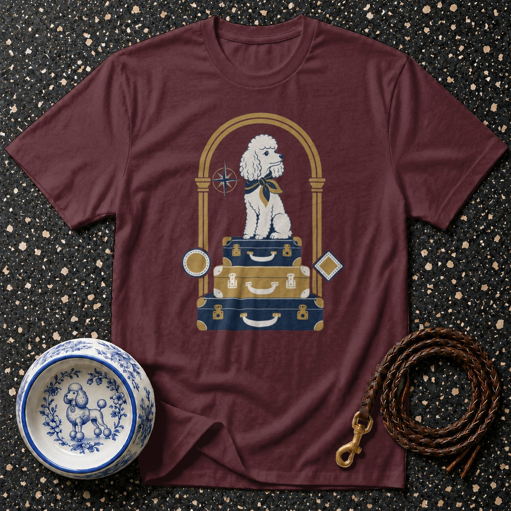 Maroon t-shirt with white poodle on stacked suitcases graphic.