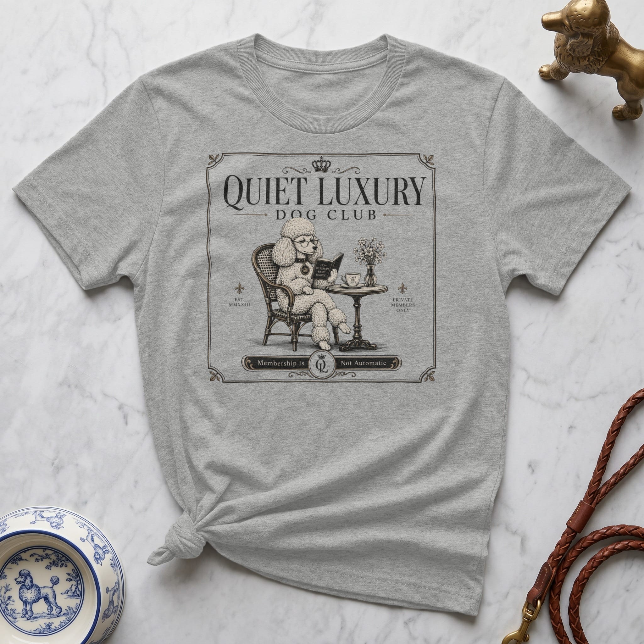 Grey t-shirt with "Quiet Luxury Dog Club" text and poodle illustration.