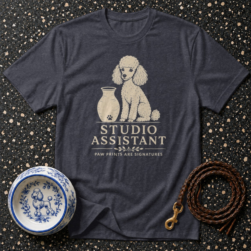 Dark t-shirt with a poodle graphic and "Studio Assistant" text.