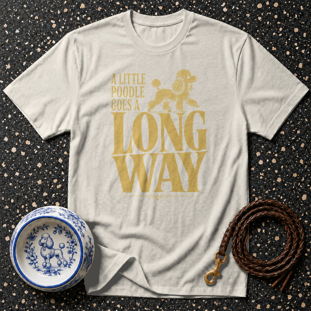 Cream t-shirt with golden poodle graphic and text "A LITTLE POODLE GOES A LONG WAY".