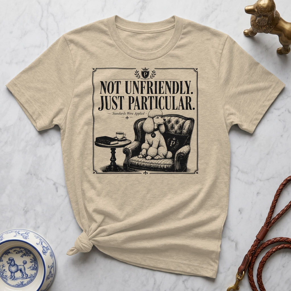 T-shirt with illustration of a poodle sitting in a chair with text "Not Unfriendly. Just Particular."