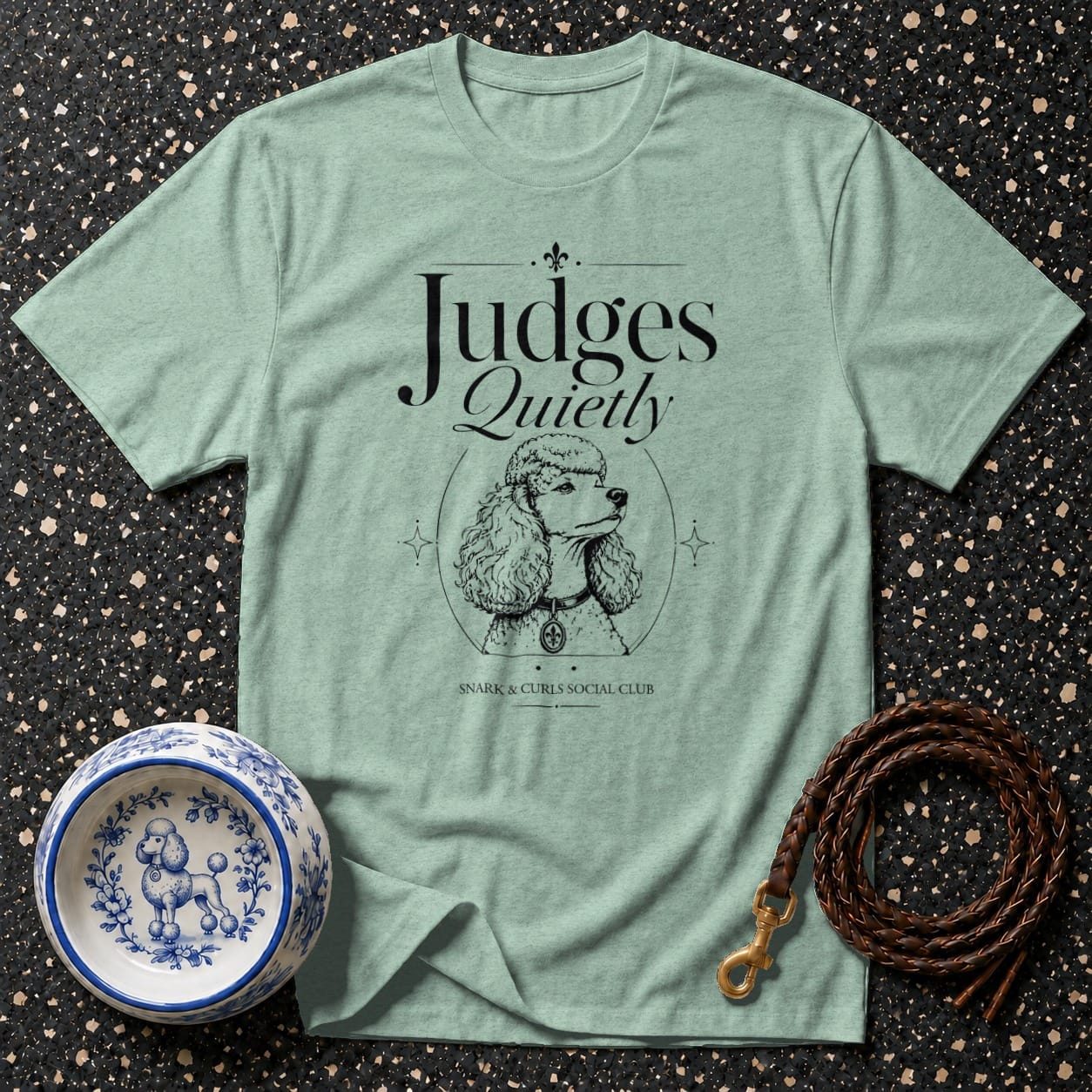 Light blue t-shirt with "Judges Quietly" text and poodle illustration.