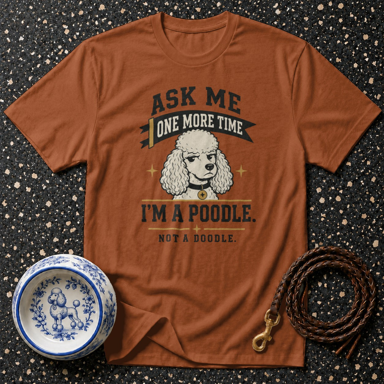 Brown t-shirt with text "Ask me one more time, I'm a poodle. Not a doodle." and poodle illustration.