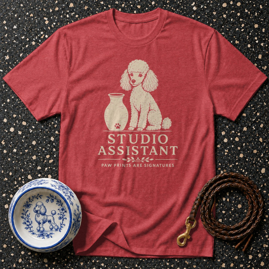 Red t-shirt with a cream poodle graphic and text "STUDIO ASSISTANT".