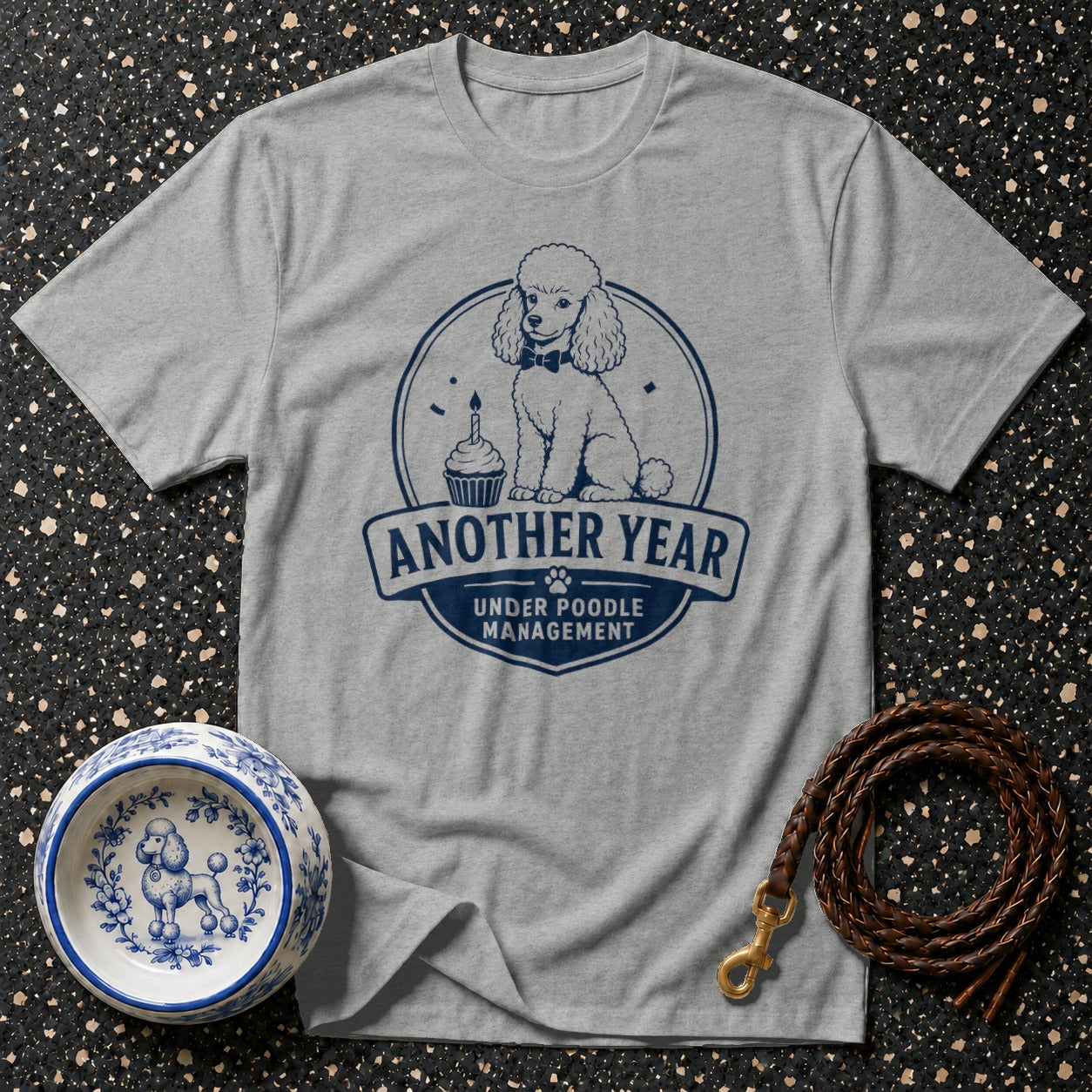 Grey t-shirt with navy poodle graphic and "Another Year Under Poodle Management" text.