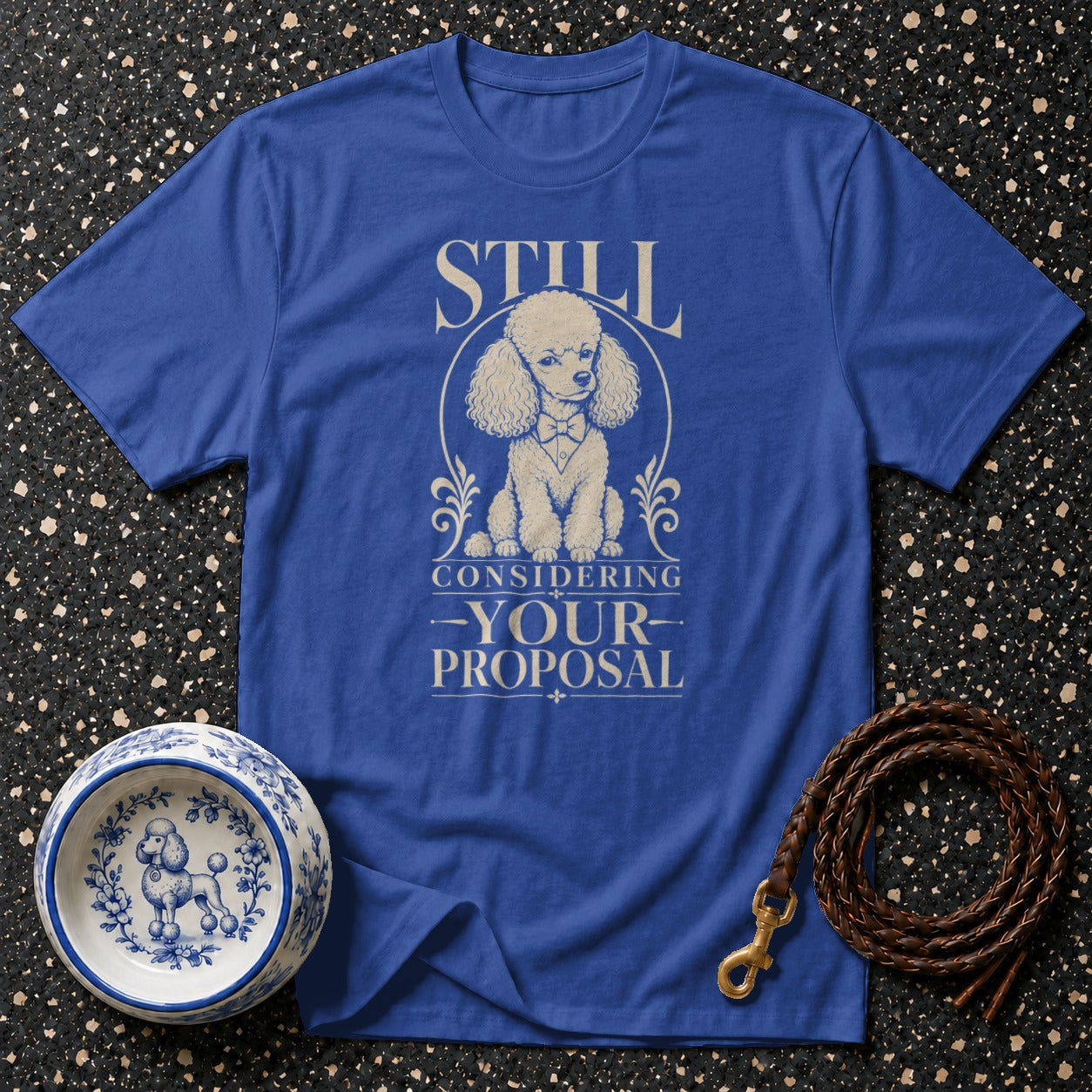 Blue t-shirt with a poodle graphic and the text "STILL CONSIDERING -YOUR- PROPOSAL".