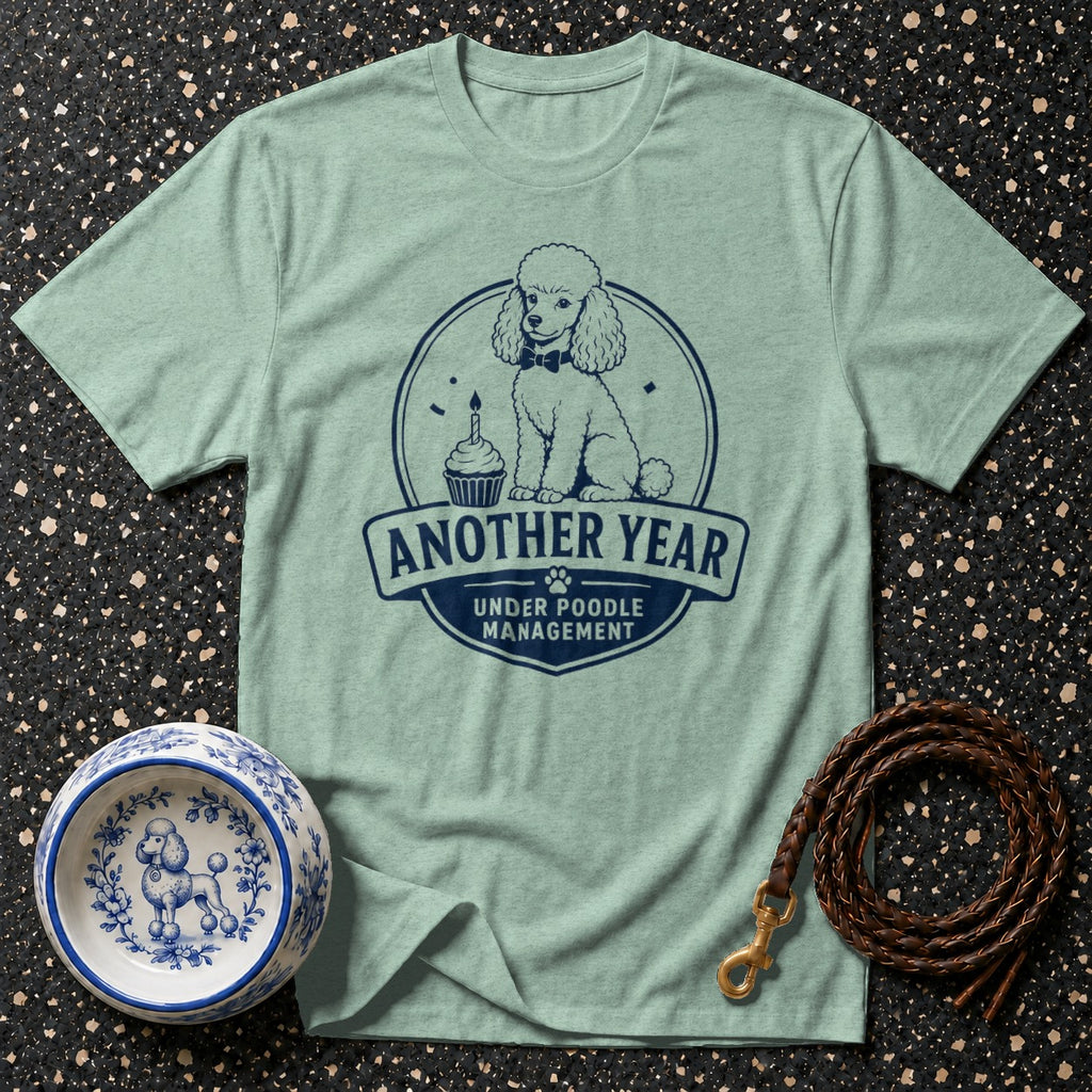 Mint t-shirt with navy graphic of a poodle and text: "Another Year Under Poodle Management."