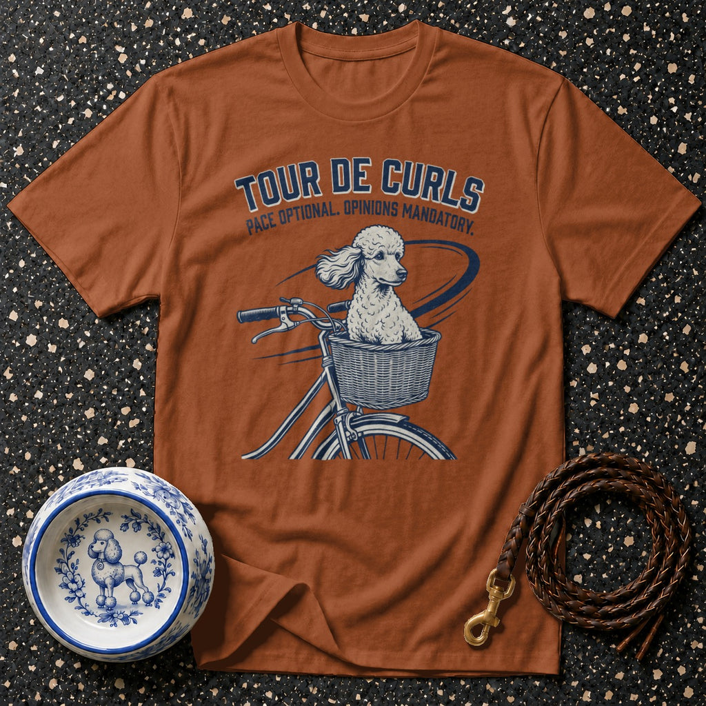 T-shirt with dog riding bicycle graphic and text "Tour De Curls".