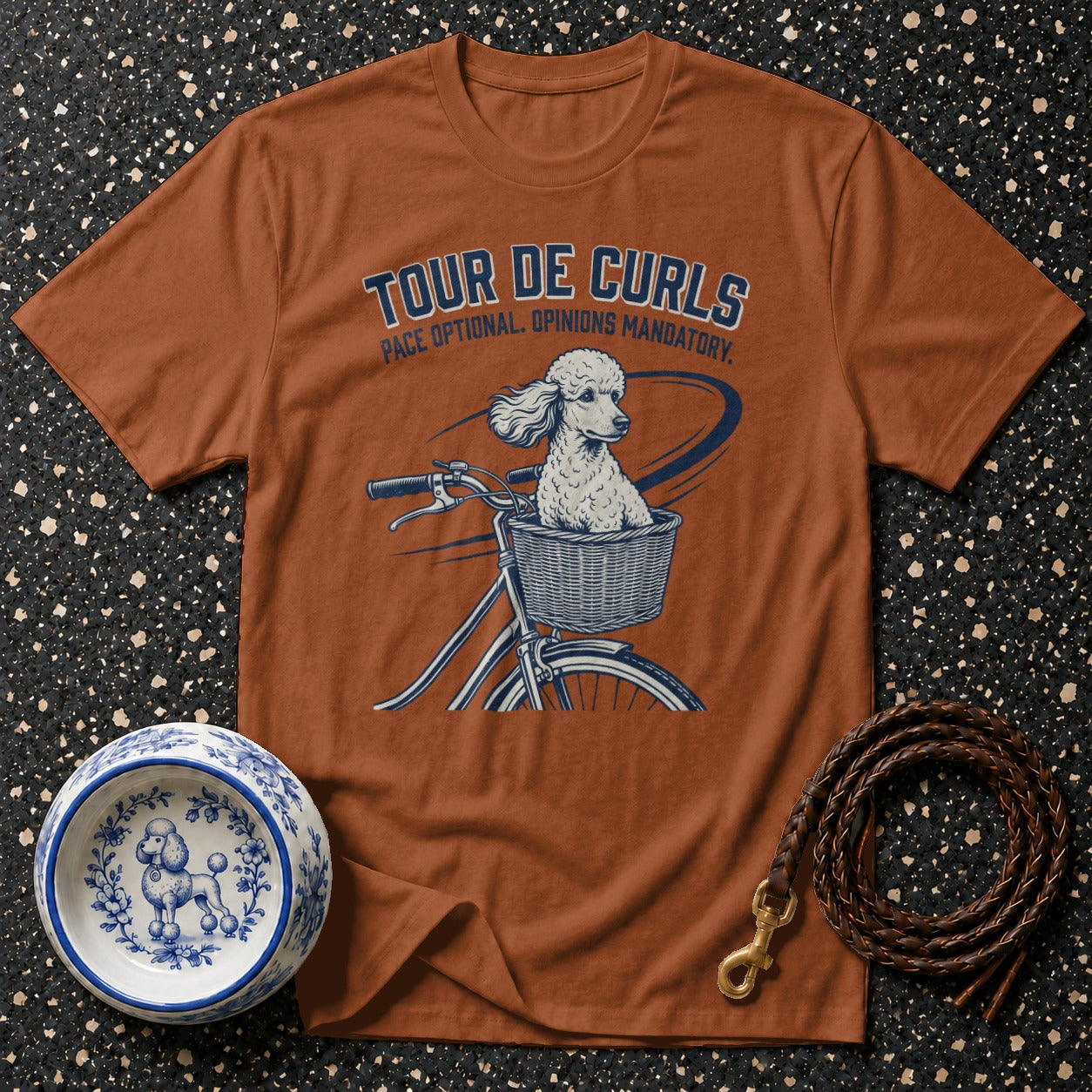 T-shirt with dog riding bicycle graphic and text "Tour De Curls".