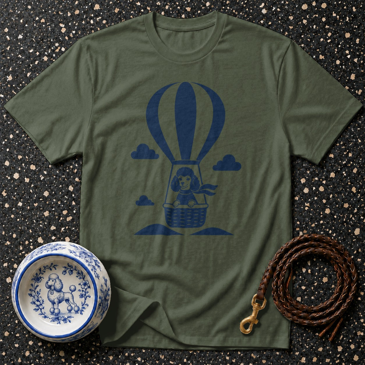 Olive green t-shirt with a navy blue poodle in a hot air balloon graphic.