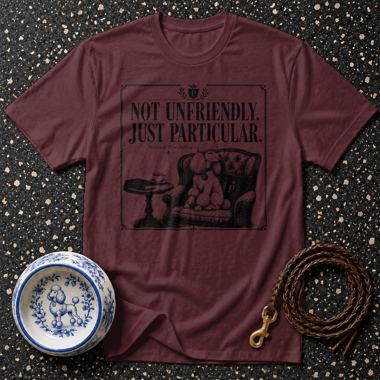 Maroon t-shirt with "Not Unfriendly. Just Particular." text and poodle graphic.