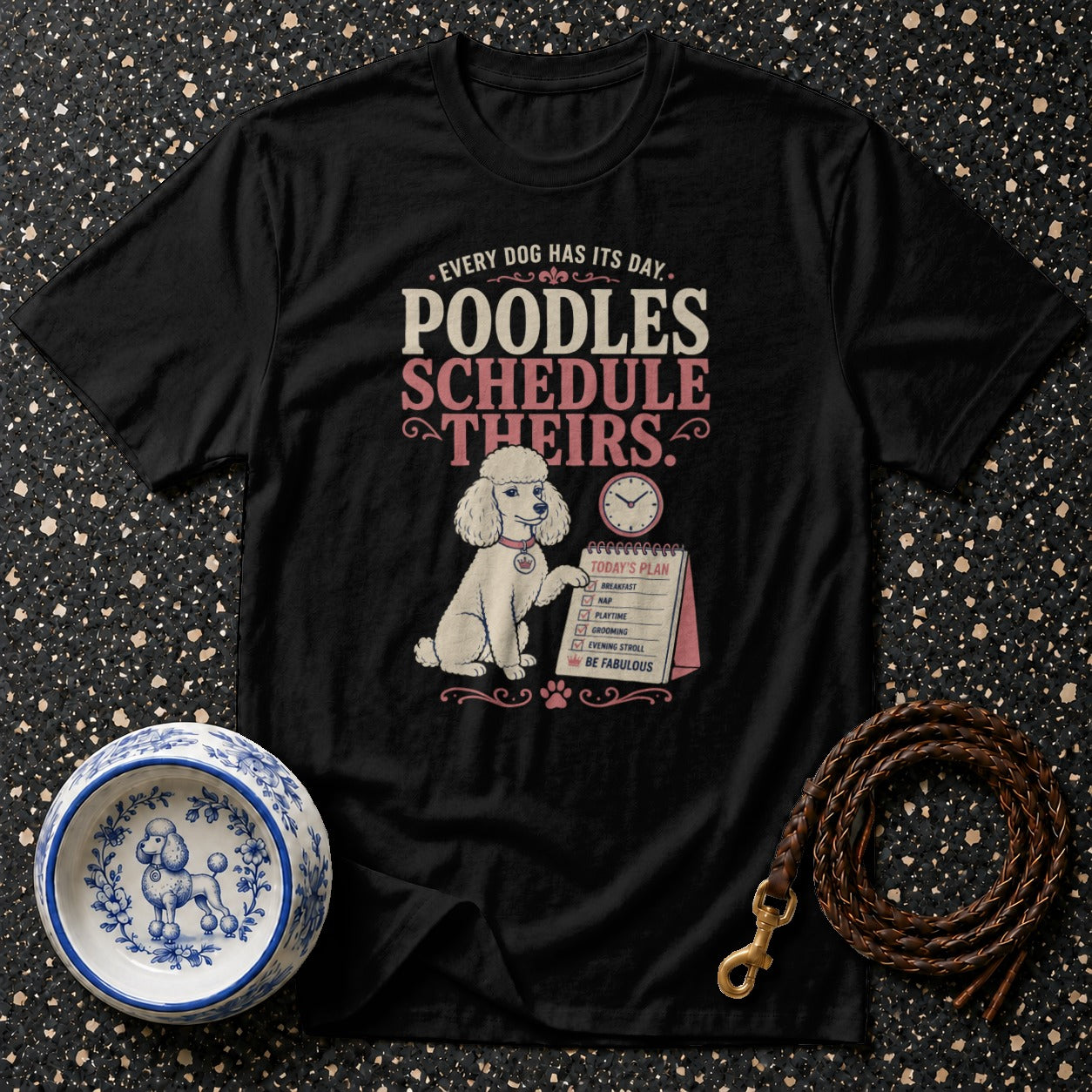 Black t-shirt with "Poodles Schedule Theirs" and a poodle with a daily plan.