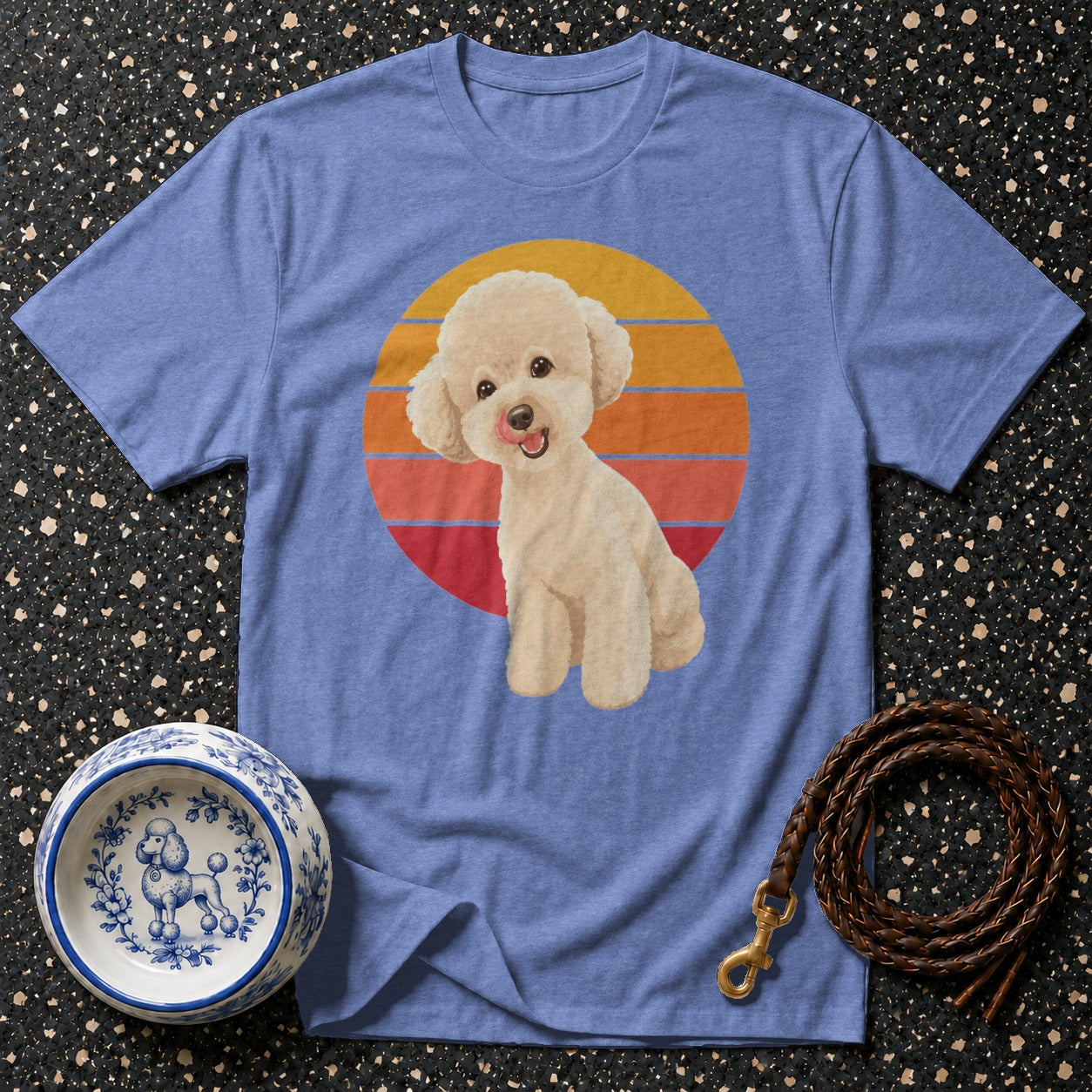 Blue t-shirt with a cream poodle graphic and a sunset background.