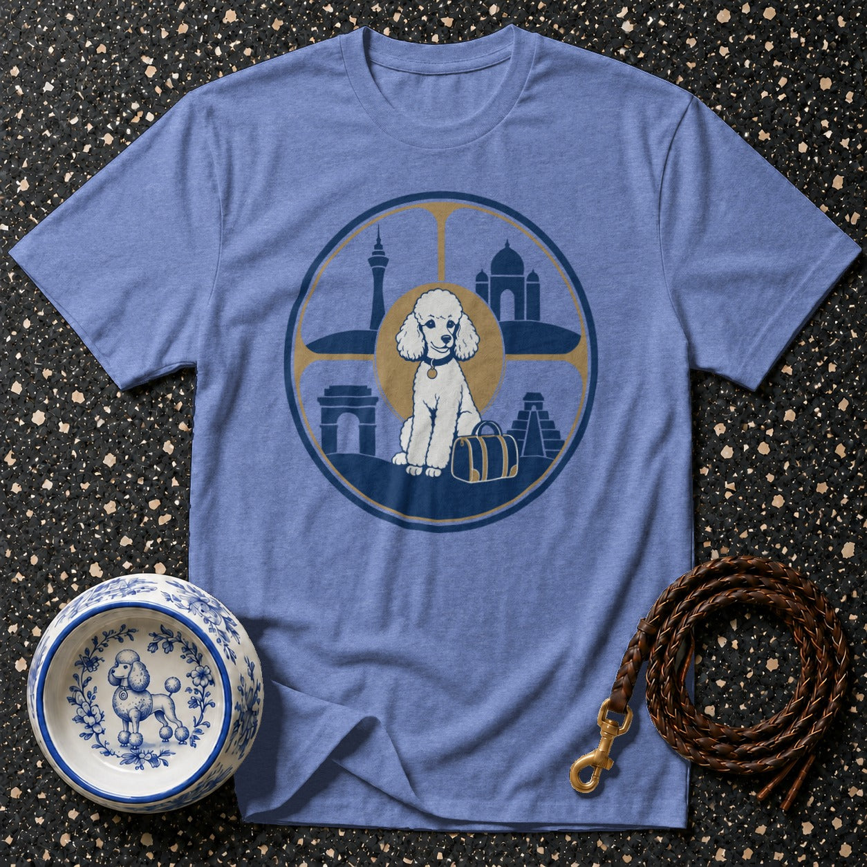 Poodle graphic tee with world landmarks and travel suitcase on blue shirt.