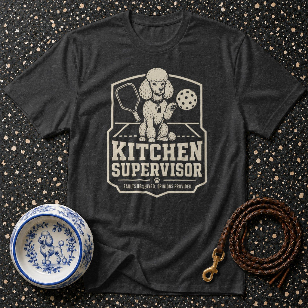 Dark t-shirt with graphic of a poodle holding a pickleball paddle and ball. Text reads "KITCHEN SUPERVISOR".