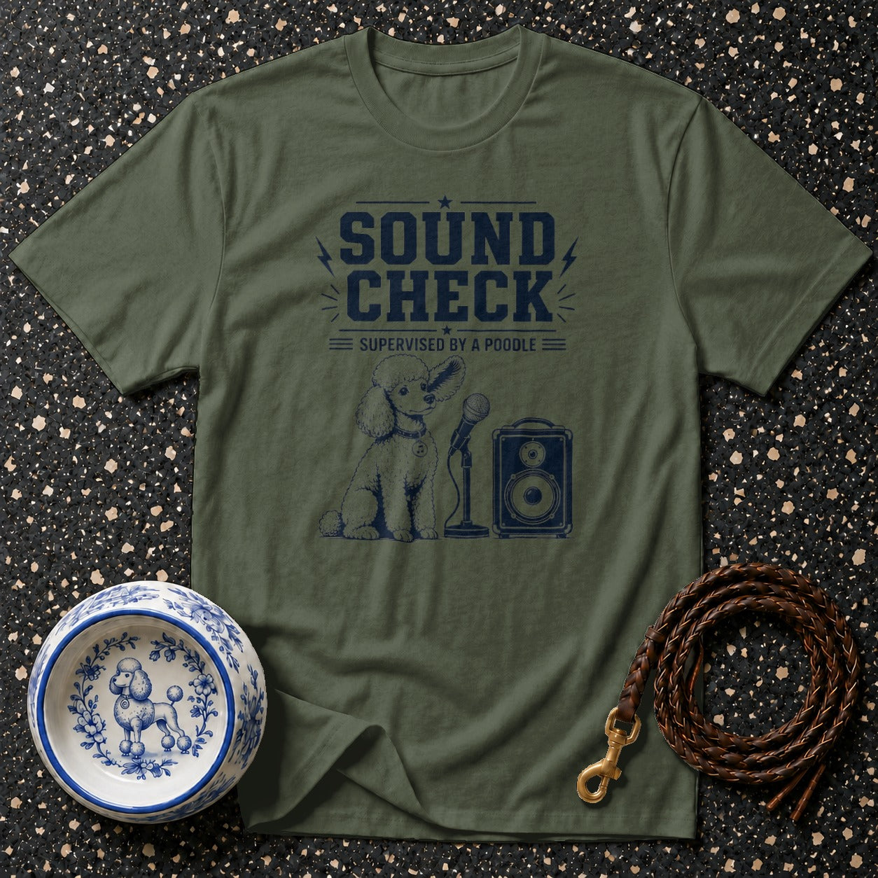 Green t-shirt with navy graphic of a poodle, microphone, and speaker, reading "Sound Check Supervised by a Poodle".