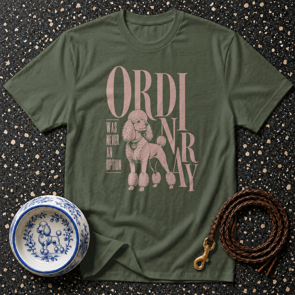 Green t-shirt with pink poodle graphic and text: "ORDINARY WAS NEVER AN OPTION"