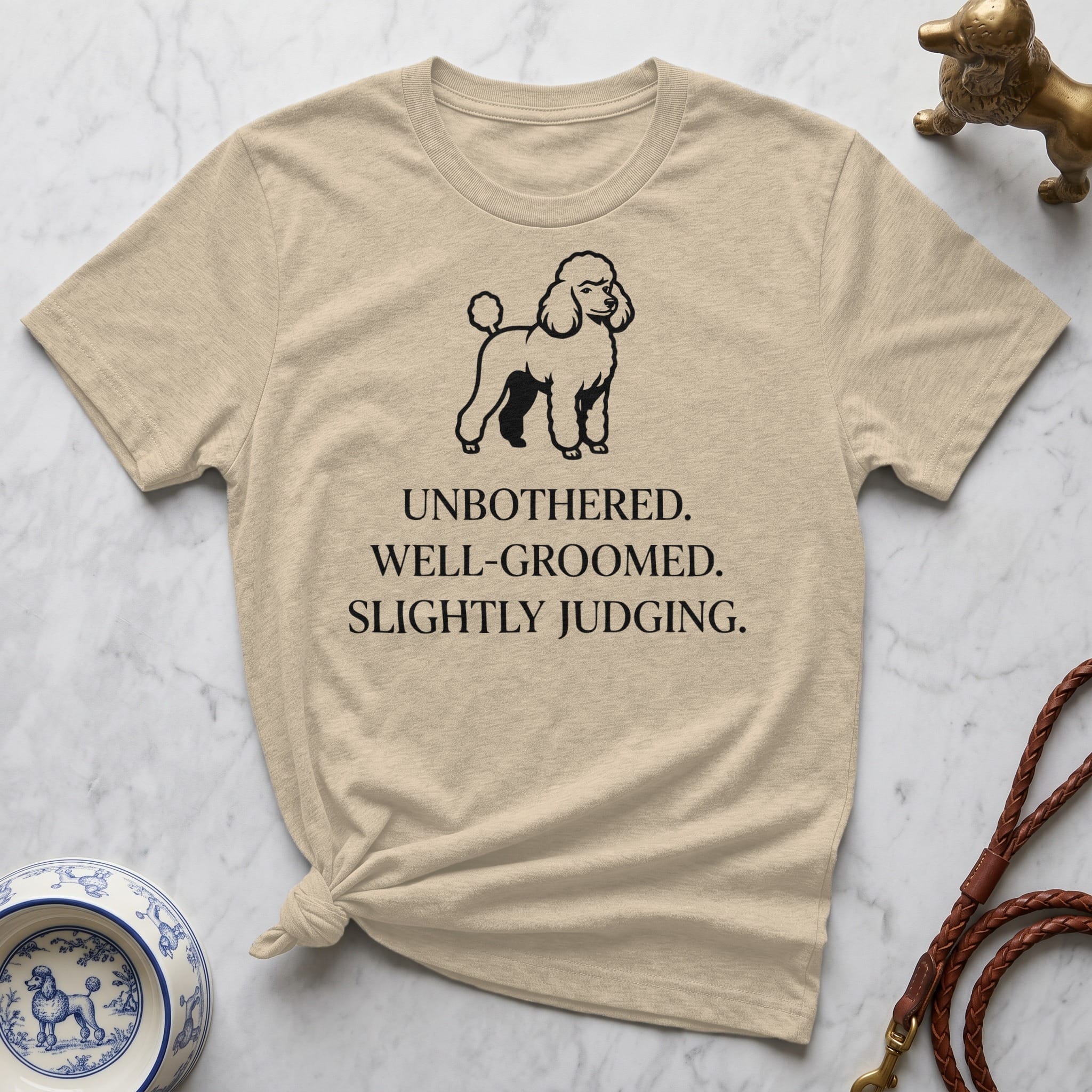 T-shirt with poodle graphic and text: UNBOTHERED. WELL-GROOMED. SLIGHTLY JUDGING.