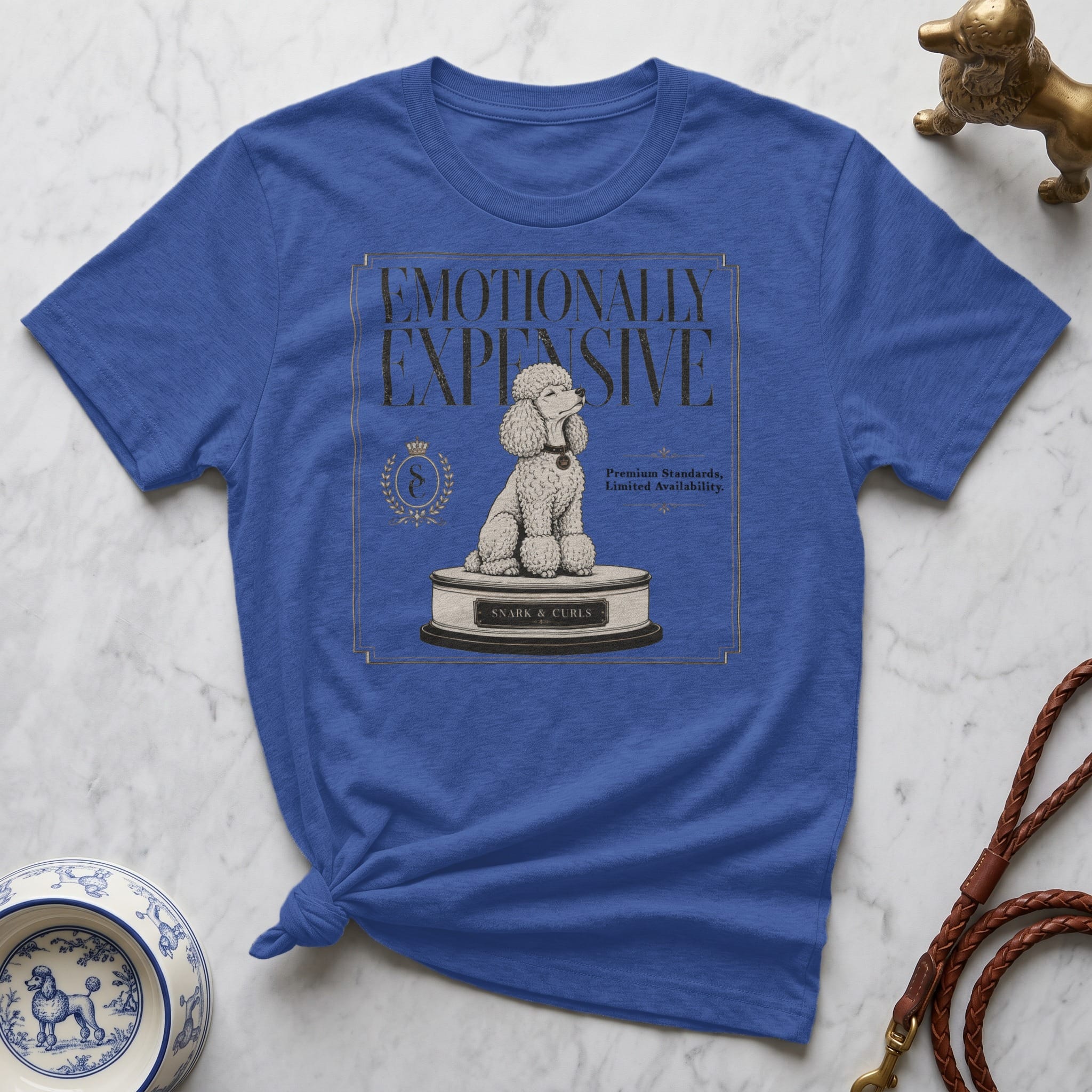 Blue t-shirt with "Emotionally Expensive" and a poodle on a pedestal.