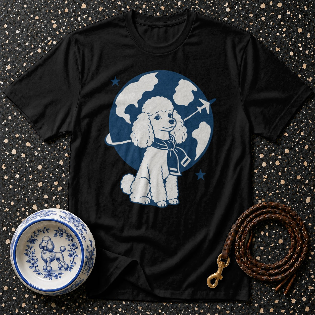 Black t-shirt with white poodle graphic wearing a scarf, set against a globe.