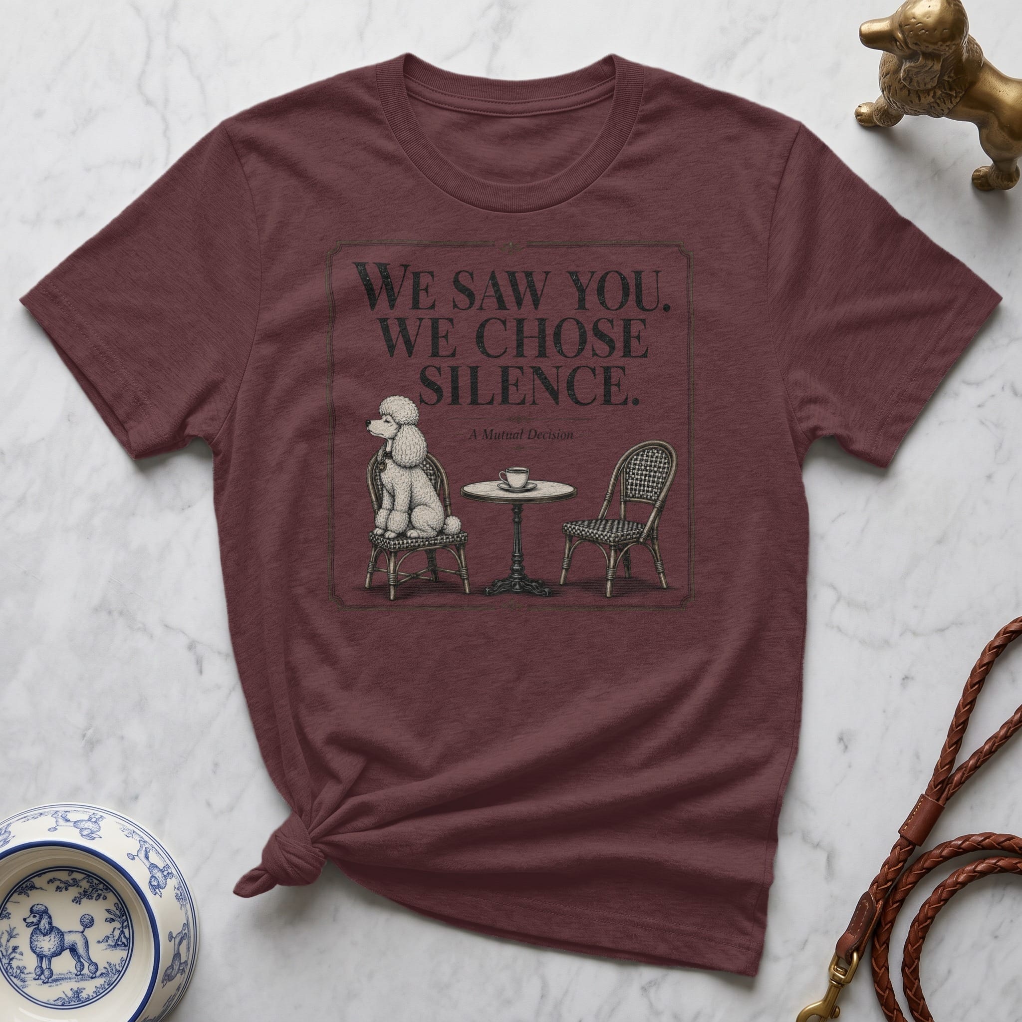 Maroon t-shirt with "We Saw. We Chose. Silence." and poodle illustration.