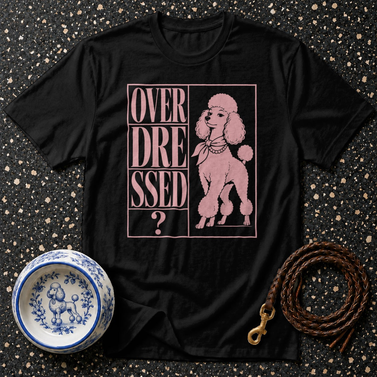 Black t-shirt with pink text and poodle graphic reading "OVER DRESSED?".