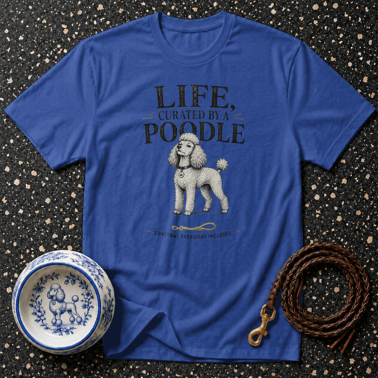Royal blue t-shirt with text and poodle graphic, a leash, and a bowl.
