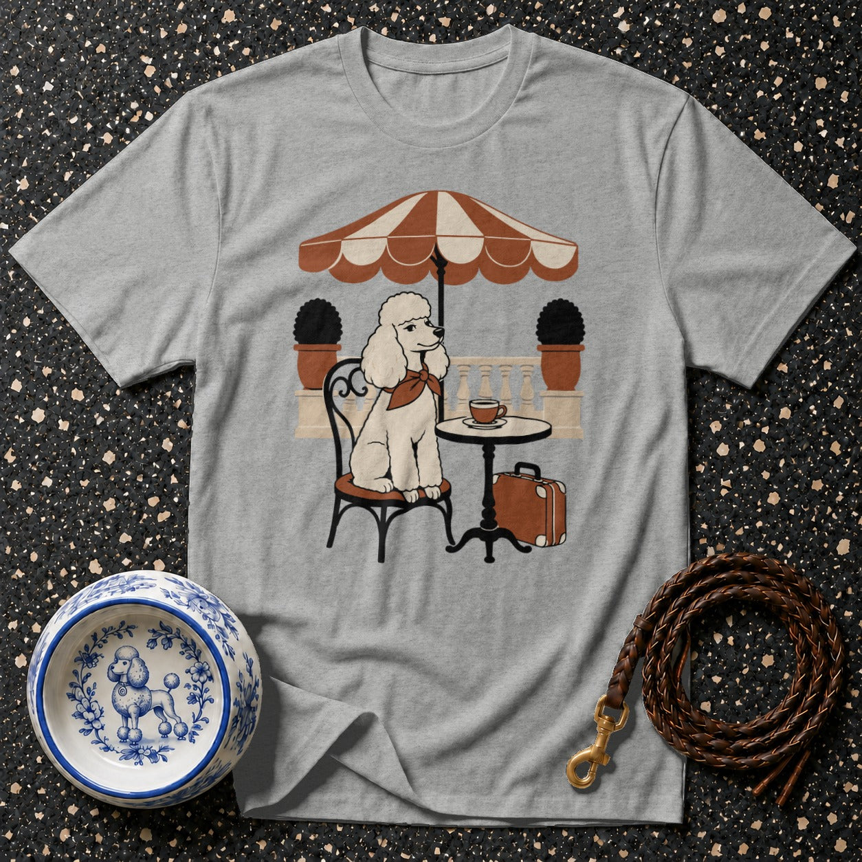 Grey t-shirt with a graphic of a white poodle sitting at a cafe table.