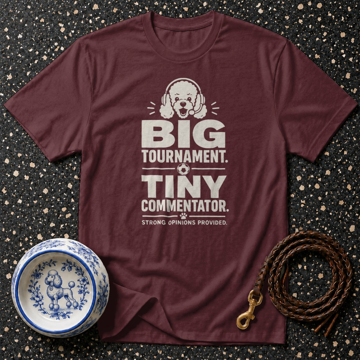 Maroon t-shirt with "Big Tournament. Tiny Commentator. Strong Opinions Provided." text.