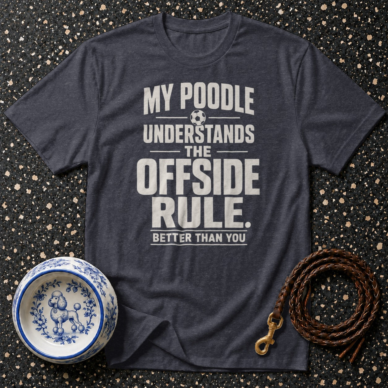 Dark grey t-shirt with text "My poodle understands the offside rule. Better than you." with a soccer ball graphic.