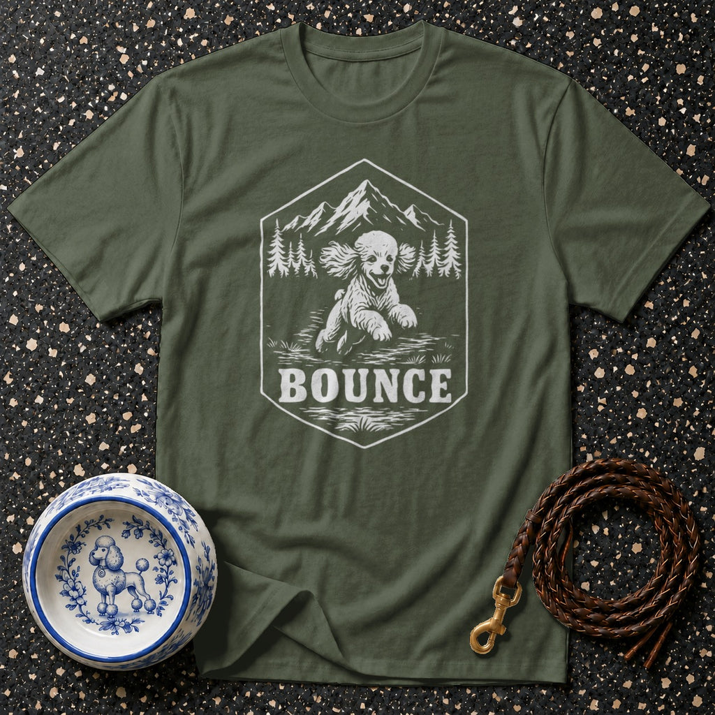 Green t-shirt with a hexagon graphic of a dog, mountains, and trees, and the word "BOUNCE".