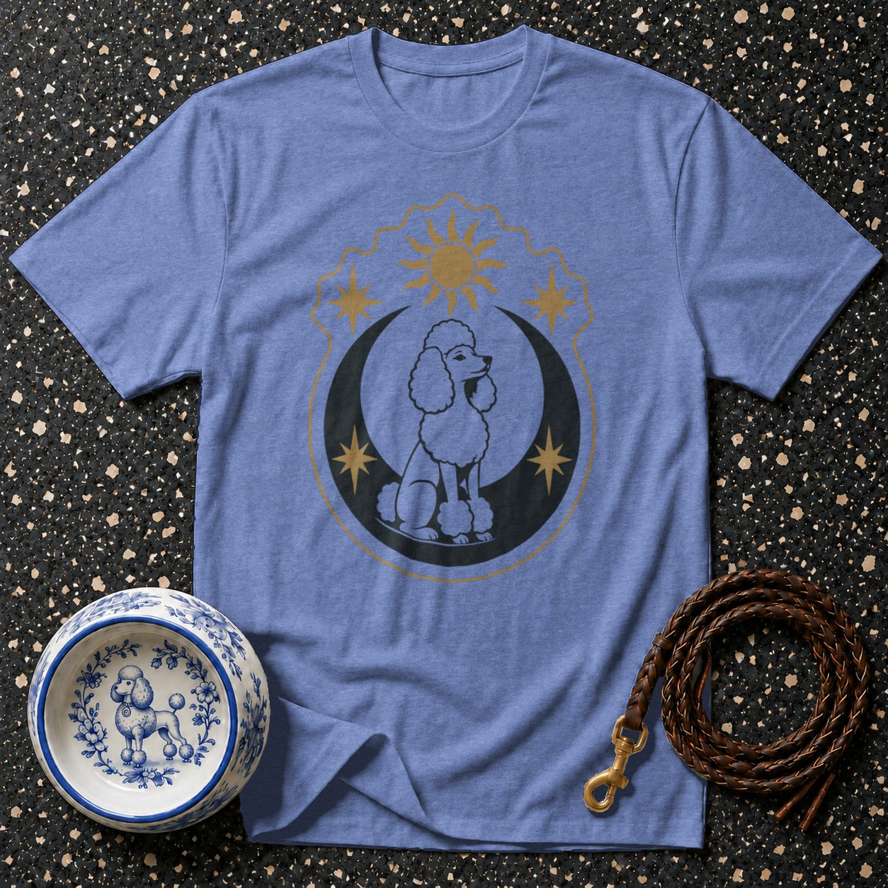 Poodle graphic on a blue t-shirt with celestial elements, dog bowl, and leash.