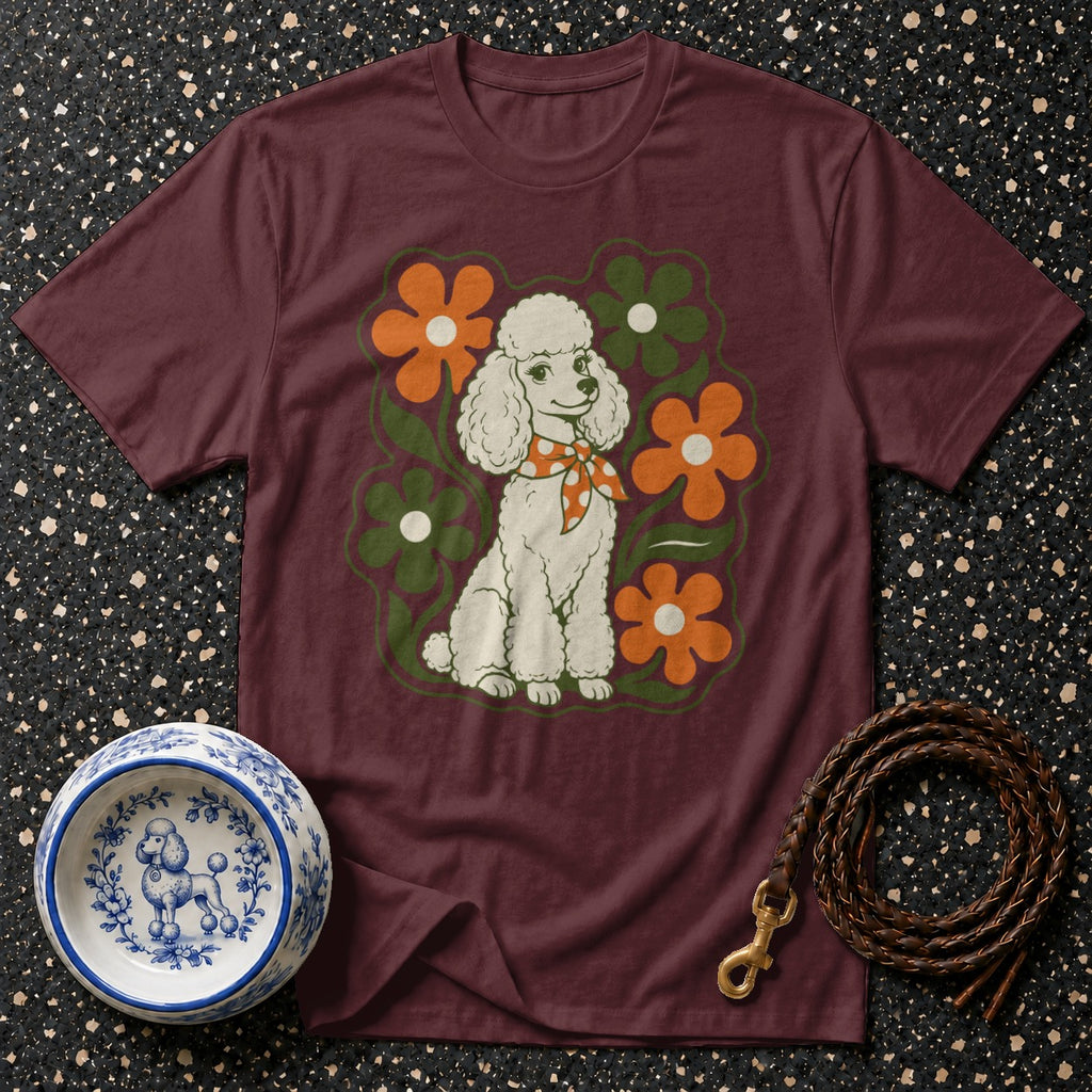 Maroon t-shirt with a white poodle and orange flowers graphic.