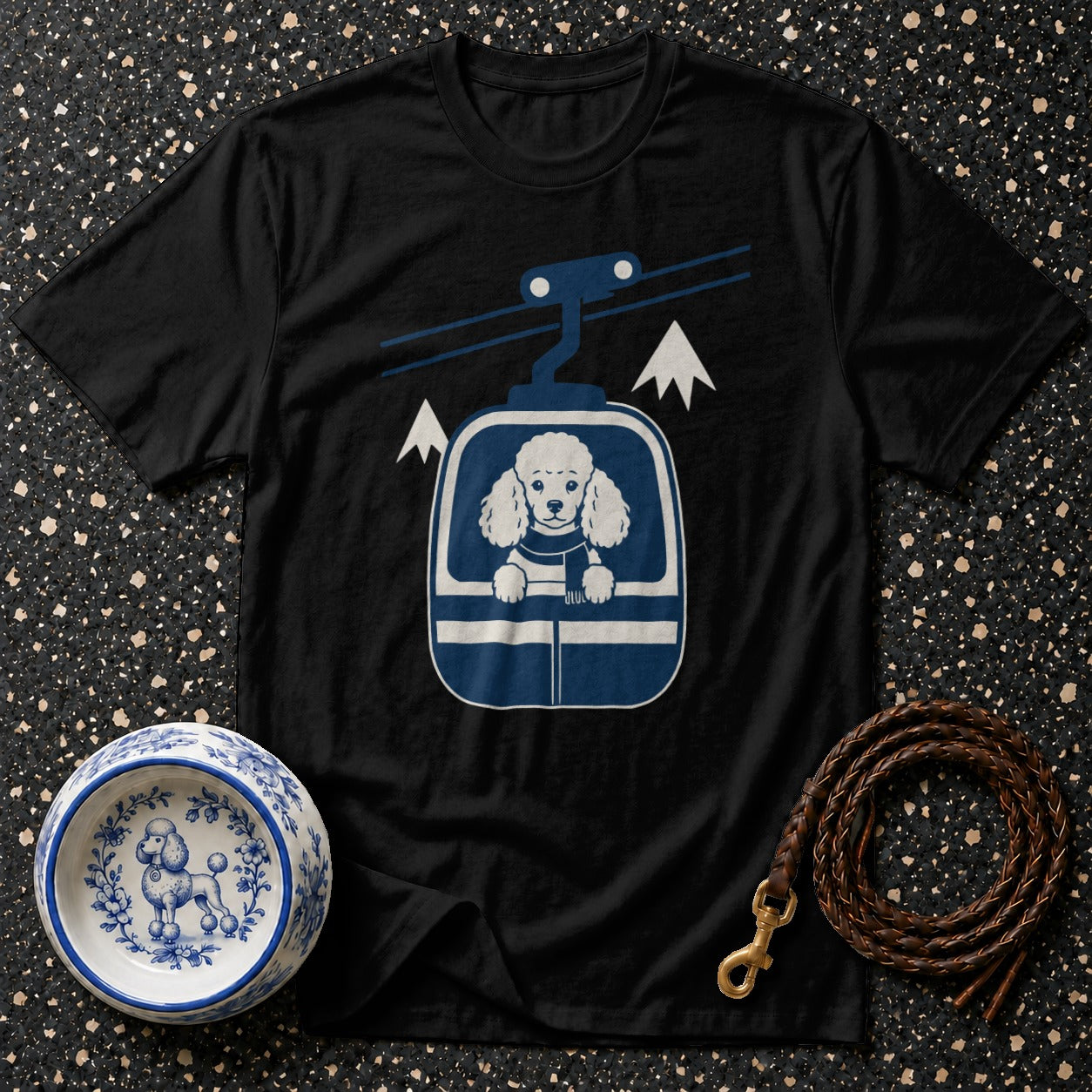 Black t-shirt with a poodle in a ski lift graphic and a dog bowl.