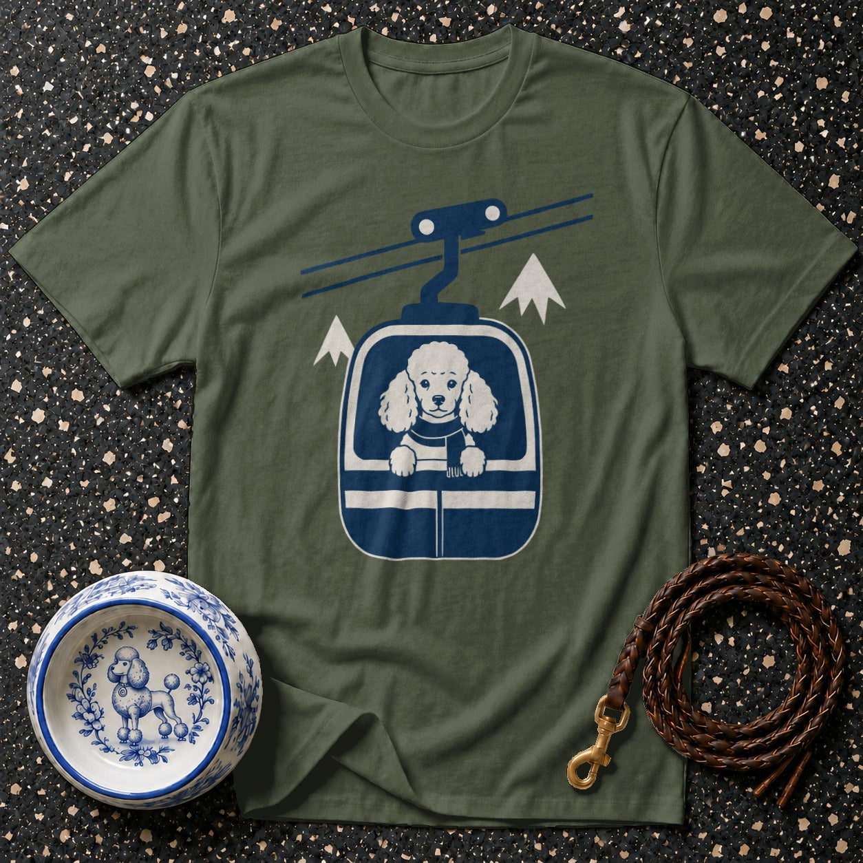 Olive green t-shirt with poodle in a ski lift graphic and dog bowl.