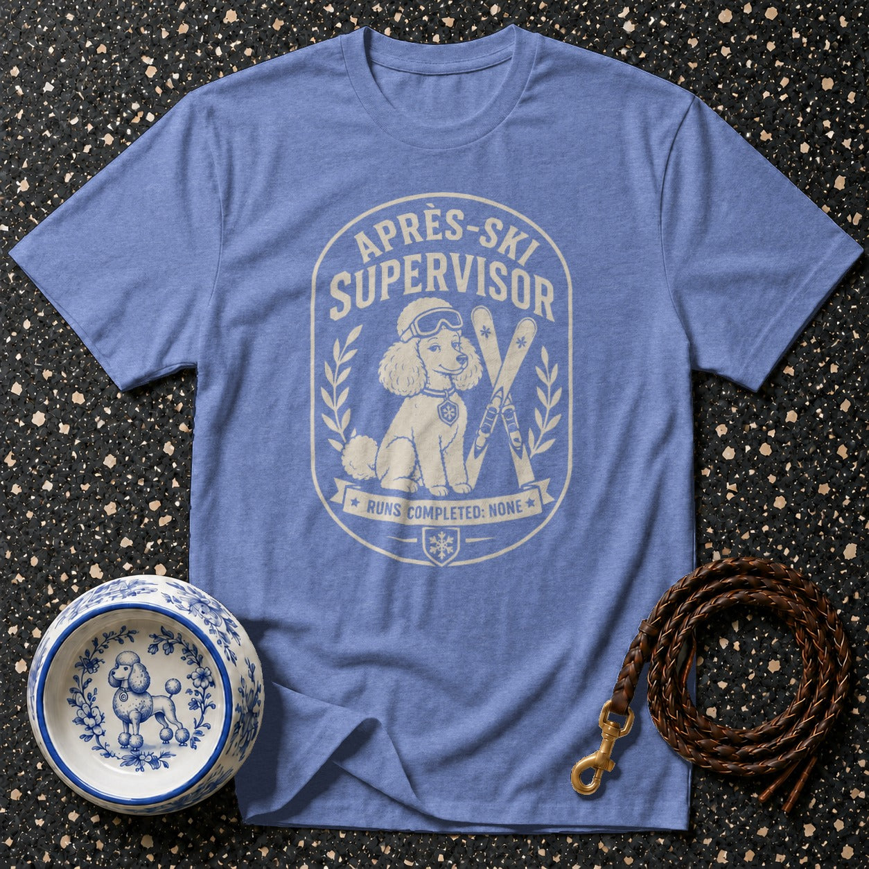 Blue t-shirt with "Après-Ski Supervisor" graphic featuring a poodle, skis, and text.