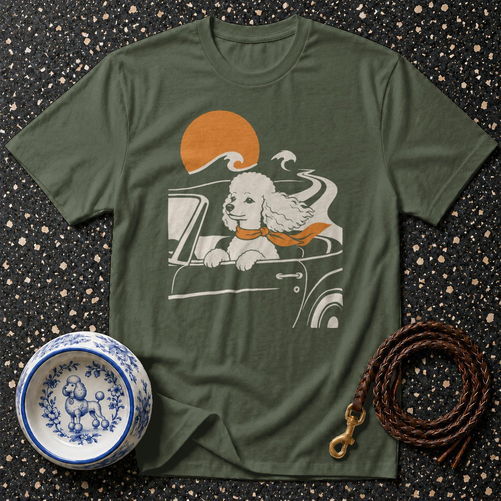 T-shirt with graphic of a poodle in a car with an orange scarf and sun.